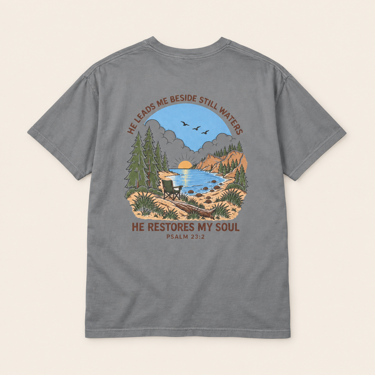 Grey Psalm 23 Christian graphic T-shirt with lake, pine trees, camp chair and He Restores My Soul design